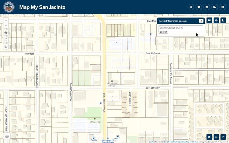 Looking up City Hall in Map My San Jacinto: from the street map with nothing selected, a loosely typed address, 595 south san jacinto av, brings up the City Hall suggestion; picking it zooms the map to City Hall, fills the lookup rows and opens the County Assessor panel, then Report opens the one-page property report.