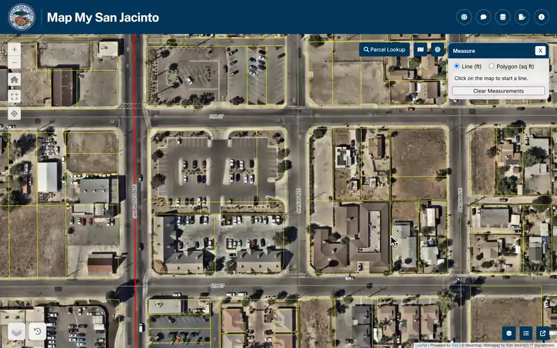 The Measure tool in Map My San Jacinto beside City Hall: a line along two streets reads 690 feet, then a polygon traced around the Civic Center block reads 87,810 square feet.